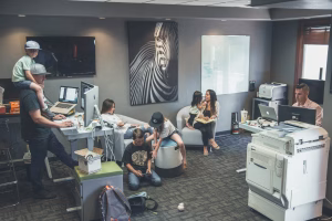 Several generations of a family in an office, some working