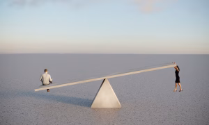 Man and woman on see saw representing gender gap
