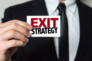 Business person holding Exit Strategy sign